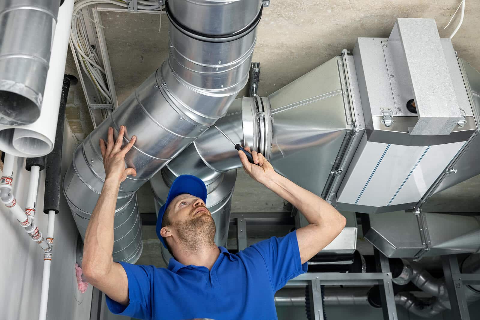 HVAC technician inspecting and repairing air ducts in Beverly Hills