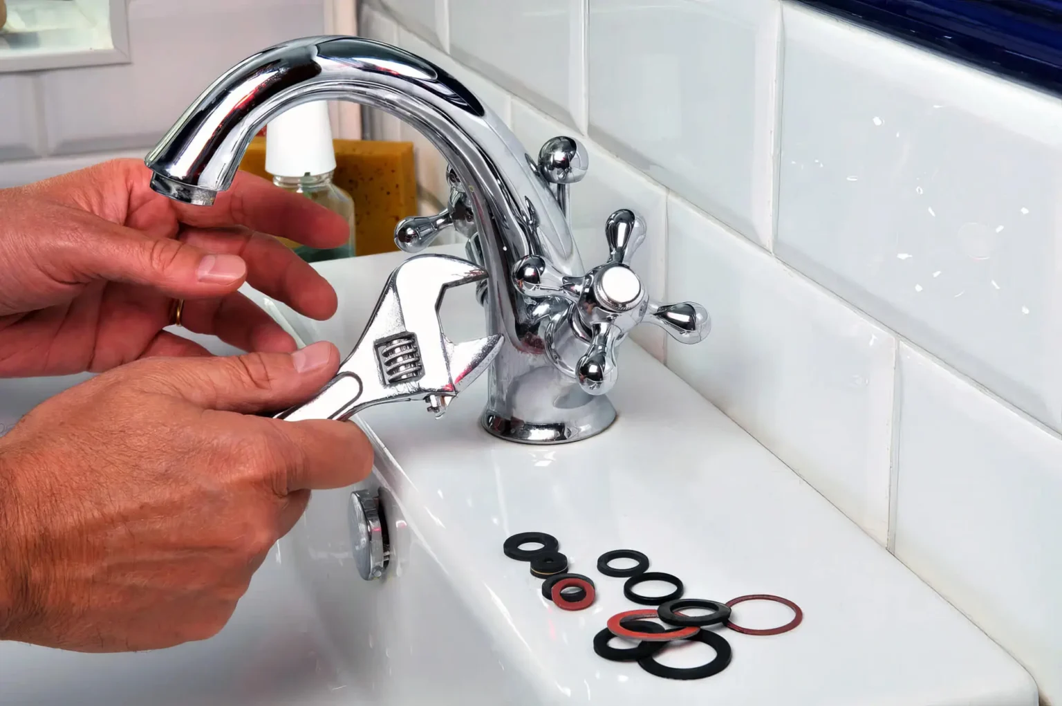 Plumber maintaining a bathroom faucet in Beverly Hills