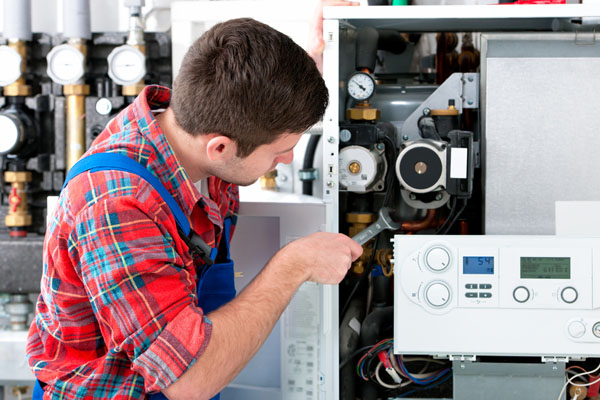 Heating technician repairing boiler controls in Beverly Hills