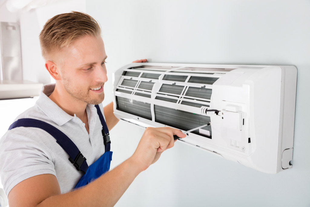 HVAC technician maintaining a ductless air conditioner in Beverly Hills