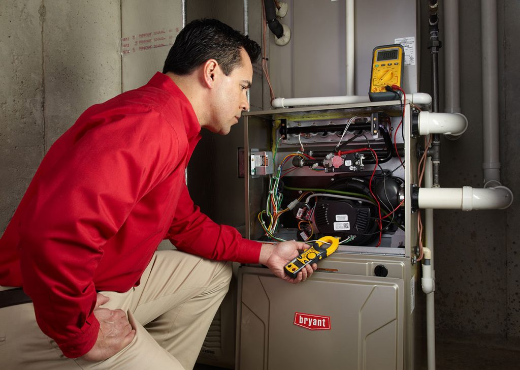 Heating technician diagnosing a furnace repair in Beverly Hills