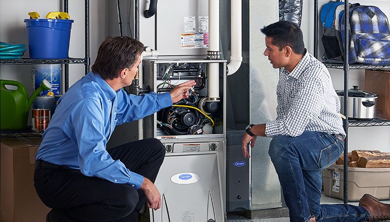 Technician evaluating a furnace for repair or replacement in Beverly Hills