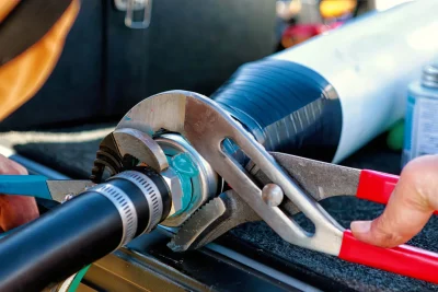 Technician repairing an industrial pipe connection in Beverly Hills