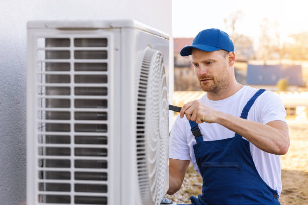 HVAC technician servicing an outdoor air conditioner in Beverly Hills